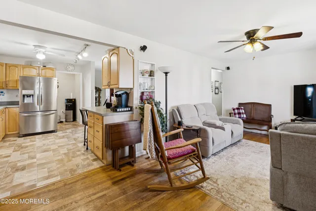 a living room with furniture and a view of kitchen