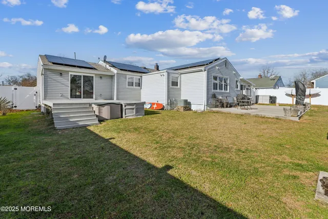 a view of a house with a yard and sitting area