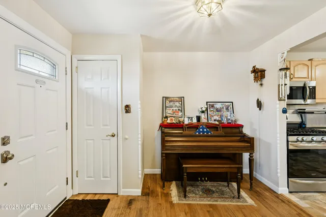 a living room with furniture and a piano table