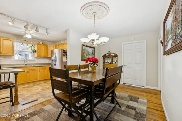 a view of a dining room with furniture and a chandelier