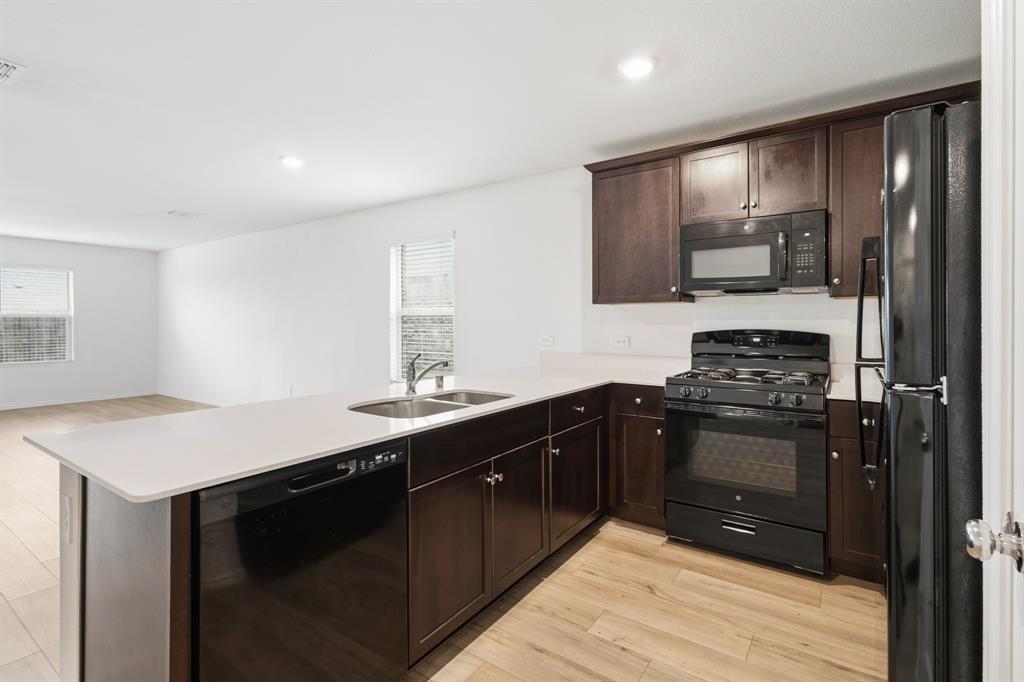 2604 Spring Time Drive Ennis, TX 75119 - Photo 8 of 21 a kitchen that has a sink and a stove top oven