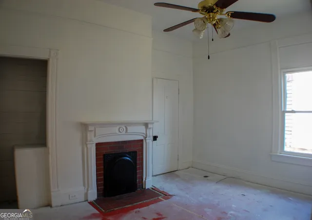 a living room with a fireplace and a window