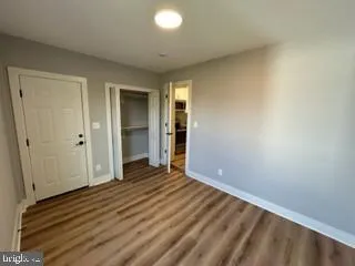 a view of a room with wooden floor and a window