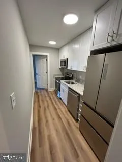 a view of a hallway with washer and dryer