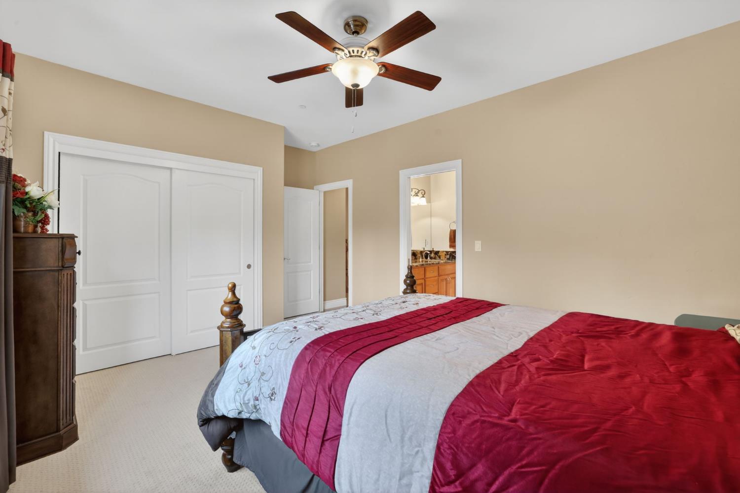 4554 Cross Creek Road Cool, CA 95614 - Photo 41 of 92 a bedroom with a bed and a chandelier