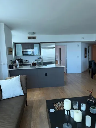 a kitchen with kitchen island stainless steel appliances a sink stove and cabinets