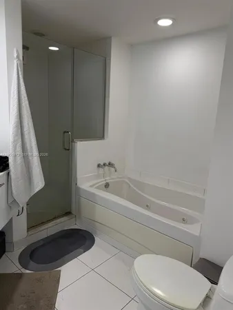 a bathroom with a toilet a sink and bathtub