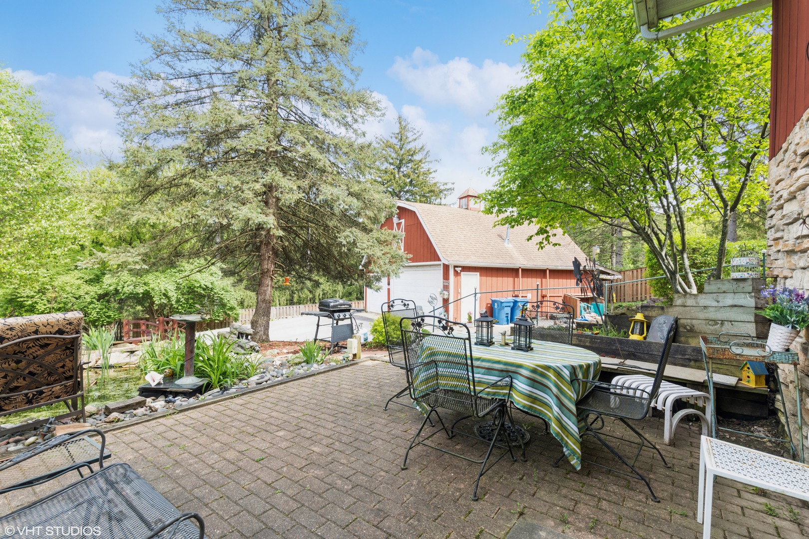 35W461 Country School Road Dundee, IL 60102 - Photo 31 of 32 a view of a patio with table and chairs and potted plants with large tree