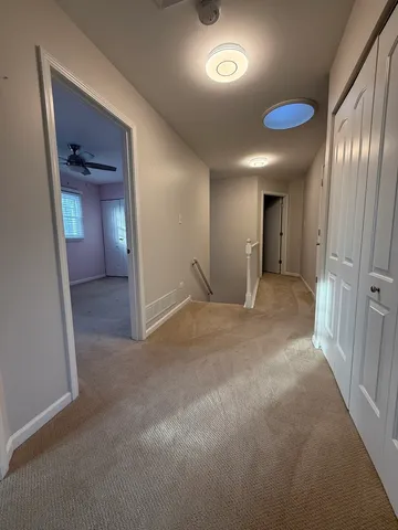 a view of a hallway with wooden shelves