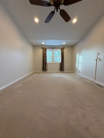 an empty room with a empty space and windows