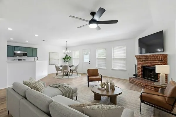 a living room with furniture a fireplace and a flat screen tv