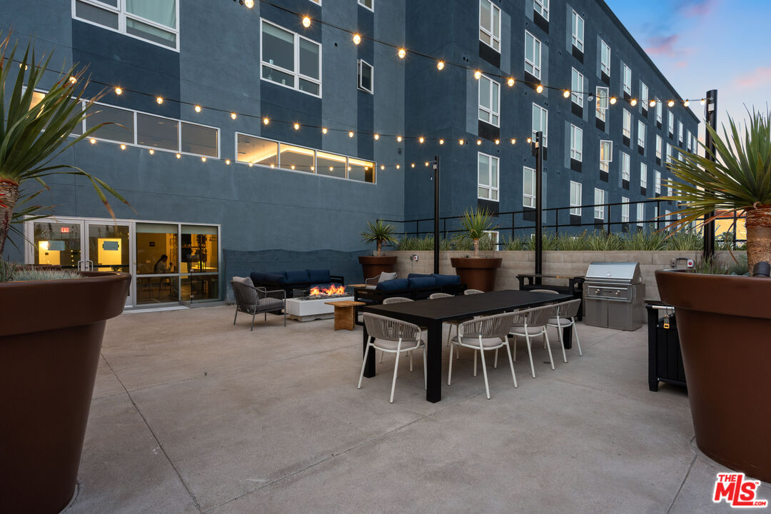 800 Western Avenue, Unit 820 Los Angeles, CA 90005 - Photo 24 of 26 a view of a building with table and chairs