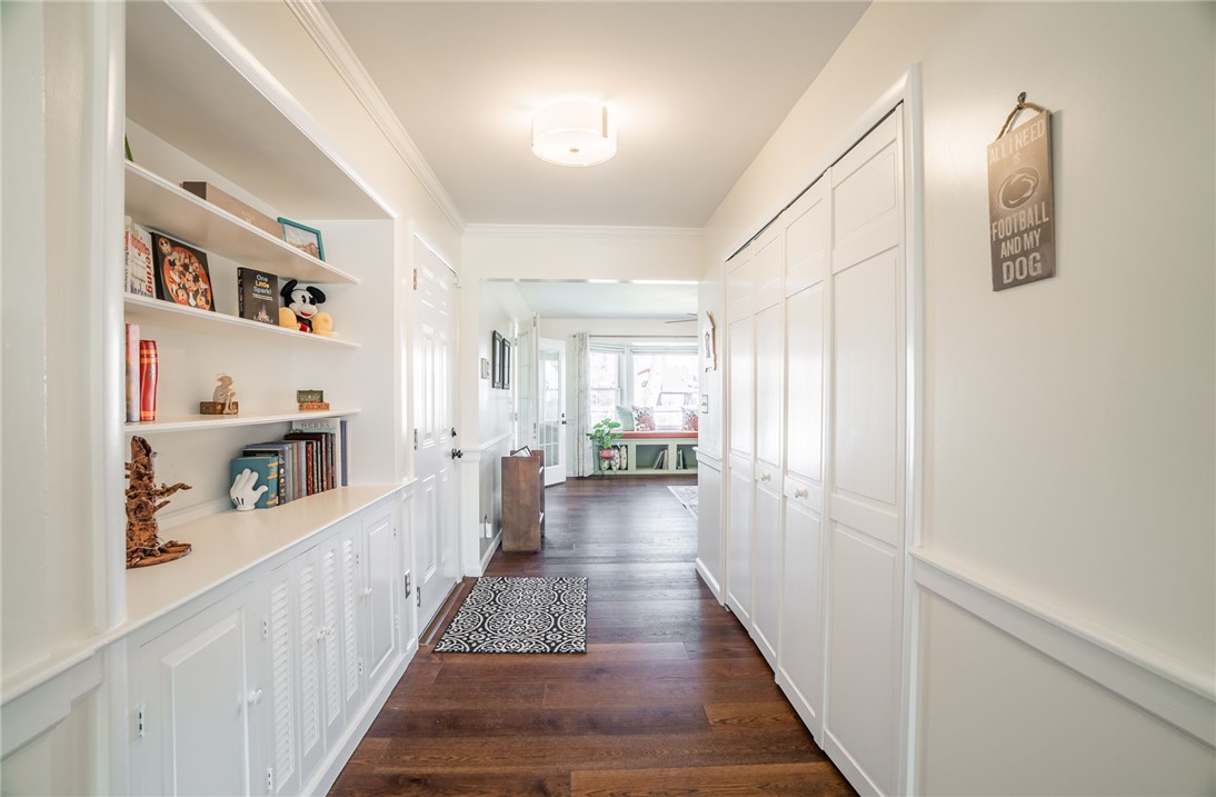 1463 Chelsea Road Troy, OH 45373 - Photo 9 of 39 This inviting hallway features rich hardwood flooring and built-in storage solutions.