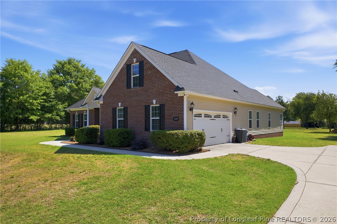 2589 June Johnson Road Raeford, NC 28376 - Photo 3 of 49 a front view of a house with garden