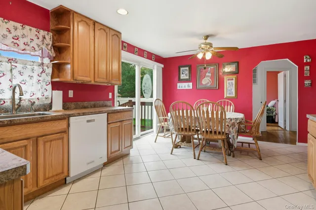 a table and chairs in a kitchen next to a window