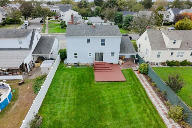 an aerial view of a house with swimming pool yard and mountain view in back