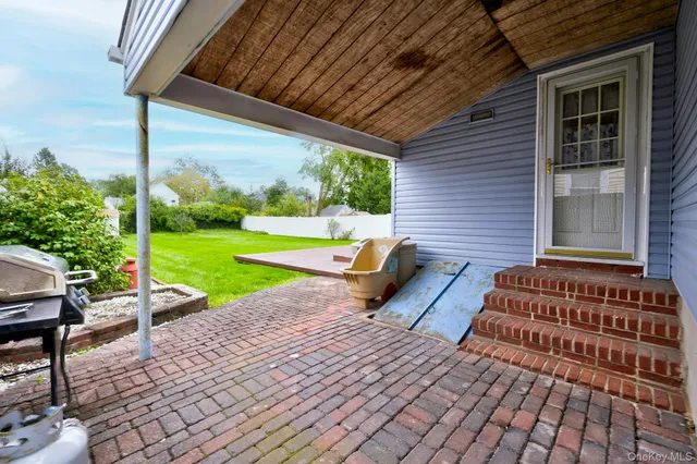 a view of backyard with table and chairs and potted plants
