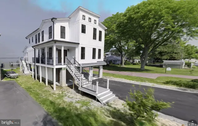 a kitchen with stainless steel appliances kitchen island granite countertop a table chairs sink and cabinets