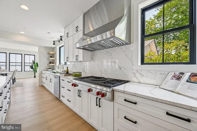 a bathroom with a double vanity sink a toilet and shower
