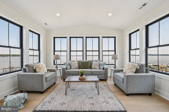 a aerial view of a house with outdoor space and lake view