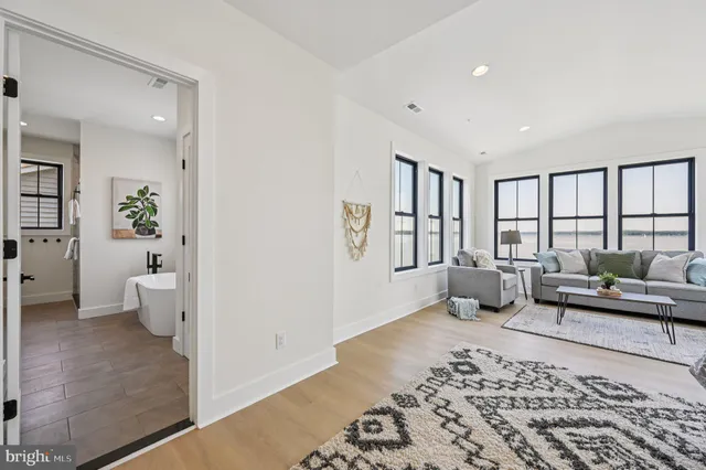 a front view of a house with lots of plants