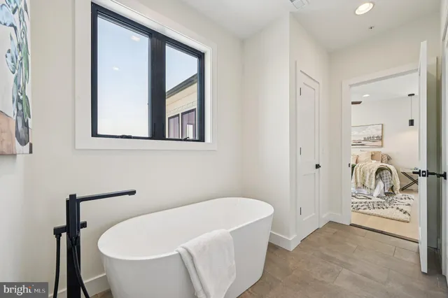 a view of a house with swimming pool and sitting area