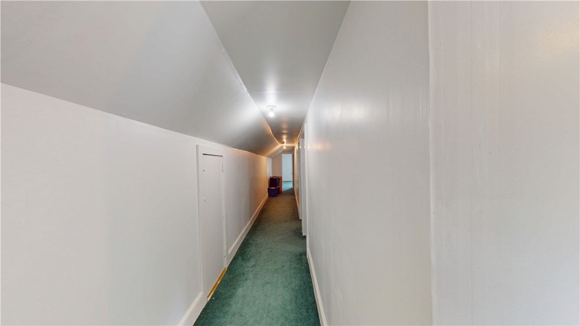 415 Church Street Pendleton, SC 29670 - Photo 31 of 35 A long, carpeted hallway extends with gently sloping walls and overhead lighting.