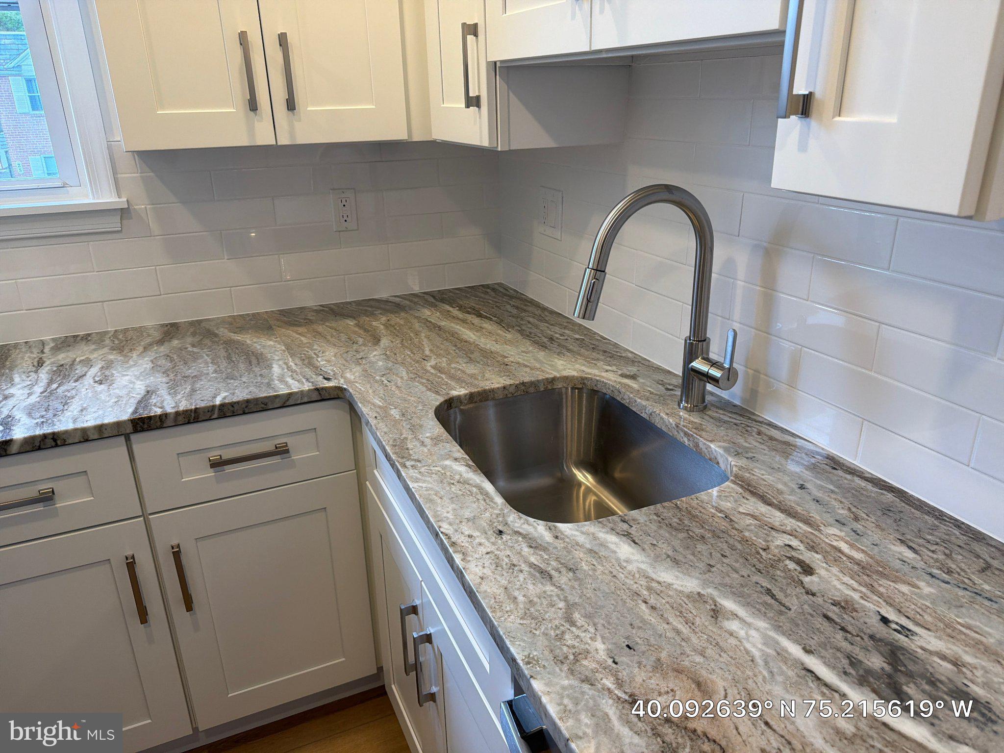 22 Windsor Road, Unit 2 Glenside, PA 19038 - Photo 12 of 29 a view of a kitchen with sink and washing machine