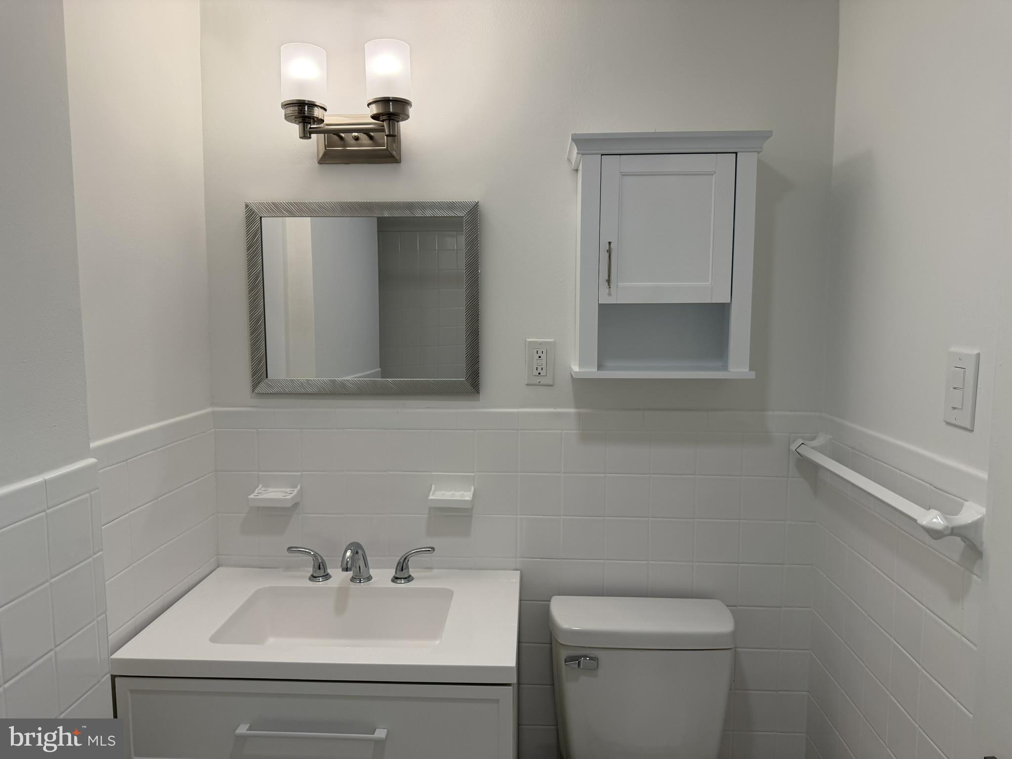 22 Windsor Road, Unit 2 Glenside, PA 19038 - Photo 27 of 29 a bathroom with a sink toilet and mirror