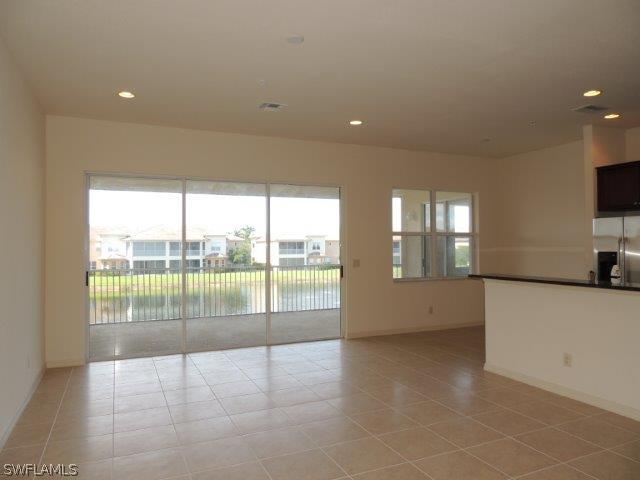 3590 Lansing Loop, Unit 201 Estero, FL 33928 - Photo 3 of 16 a view of a living room and a floor to ceiling window