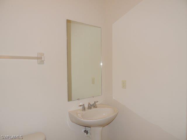 3590 Lansing Loop, Unit 201 Estero, FL 33928 - Photo 6 of 16 a bathroom with a sink and a mirror