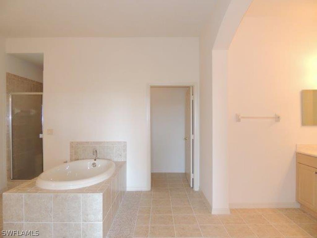 3590 Lansing Loop, Unit 201 Estero, FL 33928 - Photo 9 of 16 a bathroom with a sink and mirror