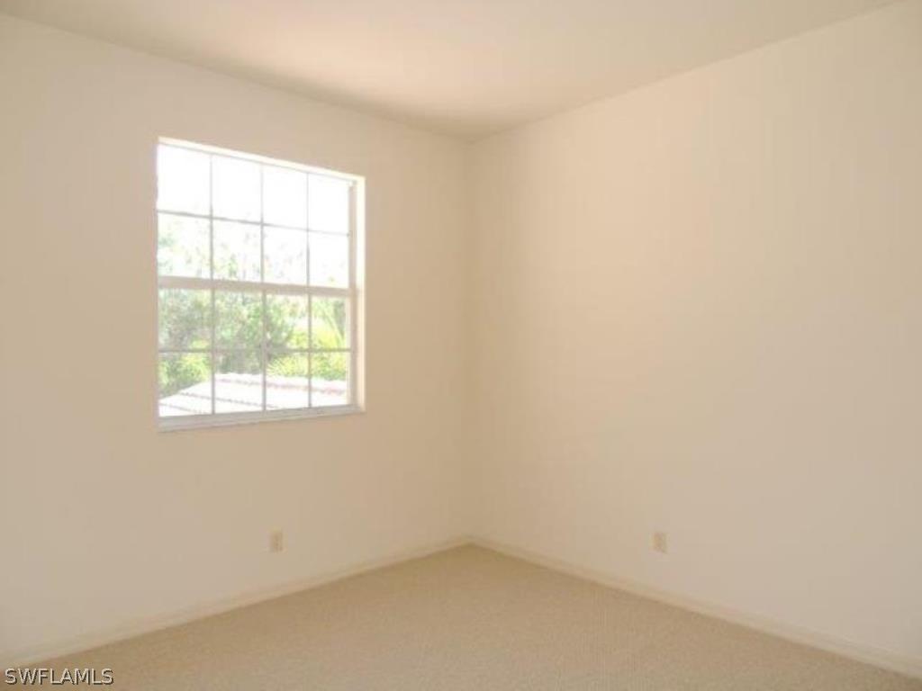 3590 Lansing Loop, Unit 201 Estero, FL 33928 - Photo 10 of 16 an empty room with a window
