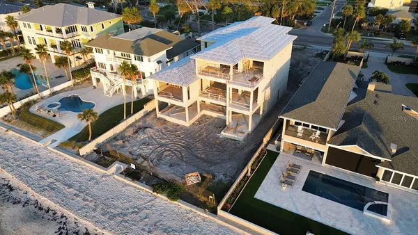 an aerial view of a residential apartment building with a yard