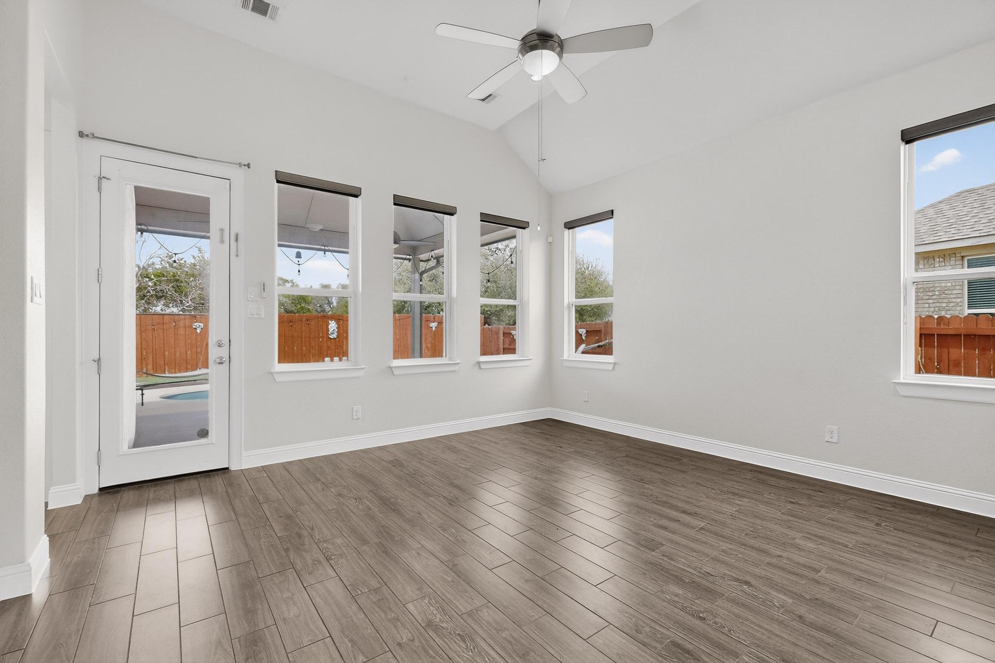 3137 Catalina Ranch Road Leander, TX 78641 - Photo 5 of 21 Spare room with lofted ceiling, dark wood finished floors, and ceiling fan