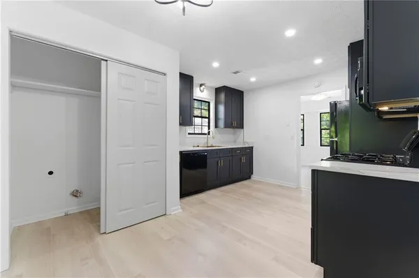 a view of kitchen with sink microwave and refrigerator