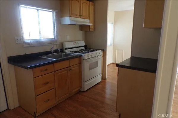 a kitchen with a sink and a stove top oven