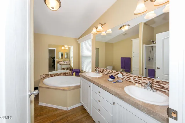 a bathroom with a double vanity sink and a mirror