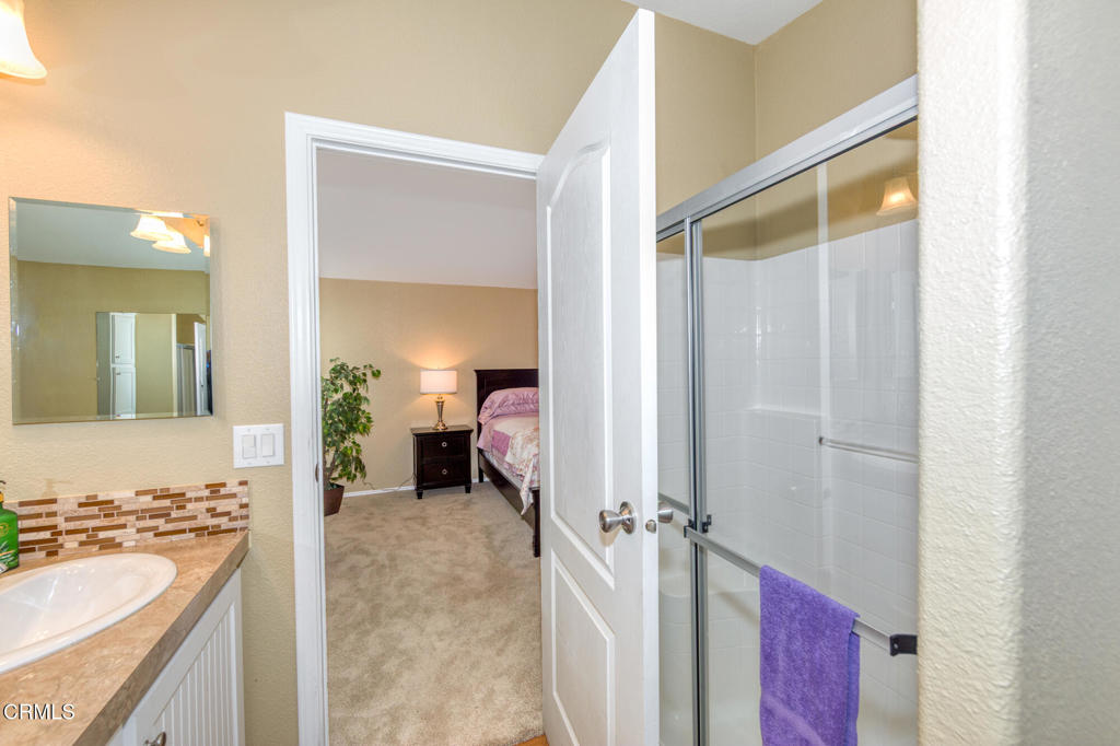 4061 Canary Lane, Unit 4061 Oxnard, CA 93033 - Photo 12 of 21 a en suite bathroom with a sink and a mirror