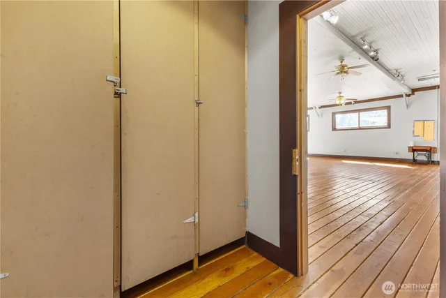 a view of a hallway with wooden floor and staircase