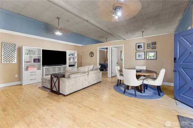 a living room with furniture wooden floor and a flat screen tv
