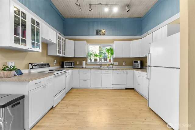a kitchen with stainless steel appliances a refrigerator sink and cabinets