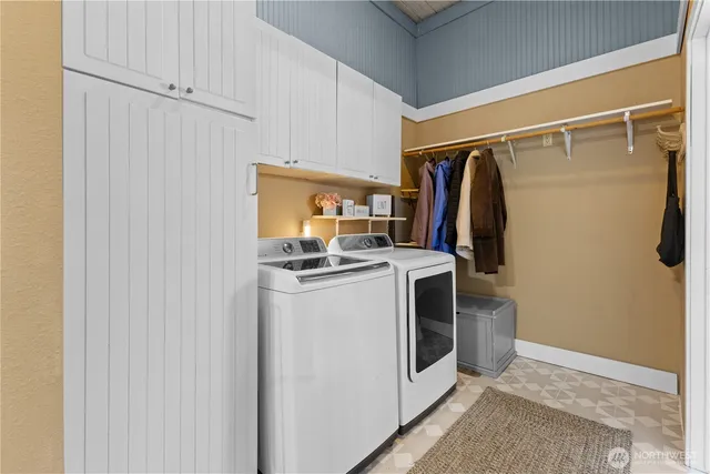 a view of a storage and utility room with washer and dryer
