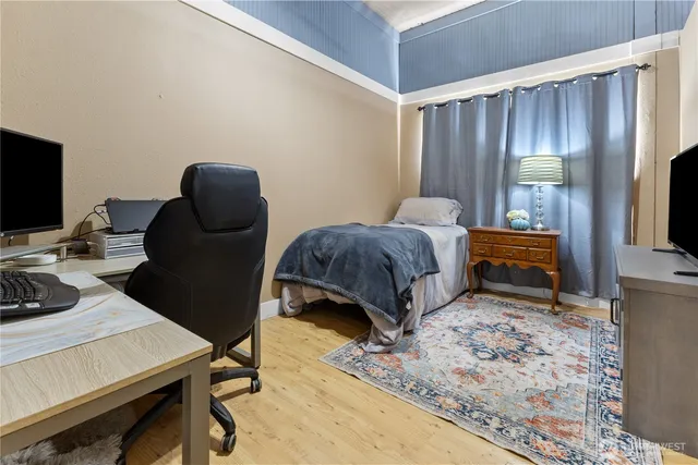 a bedroom with a bed and a television