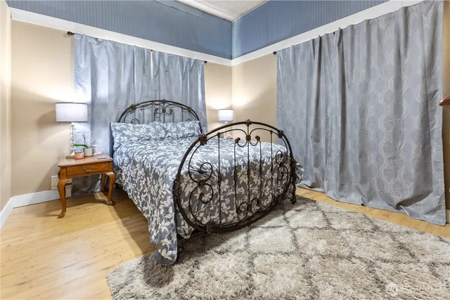 a room with a bed a mirror and a window