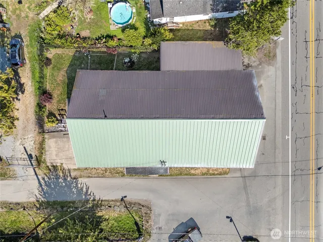 an aerial view of a house with a yard and lake view