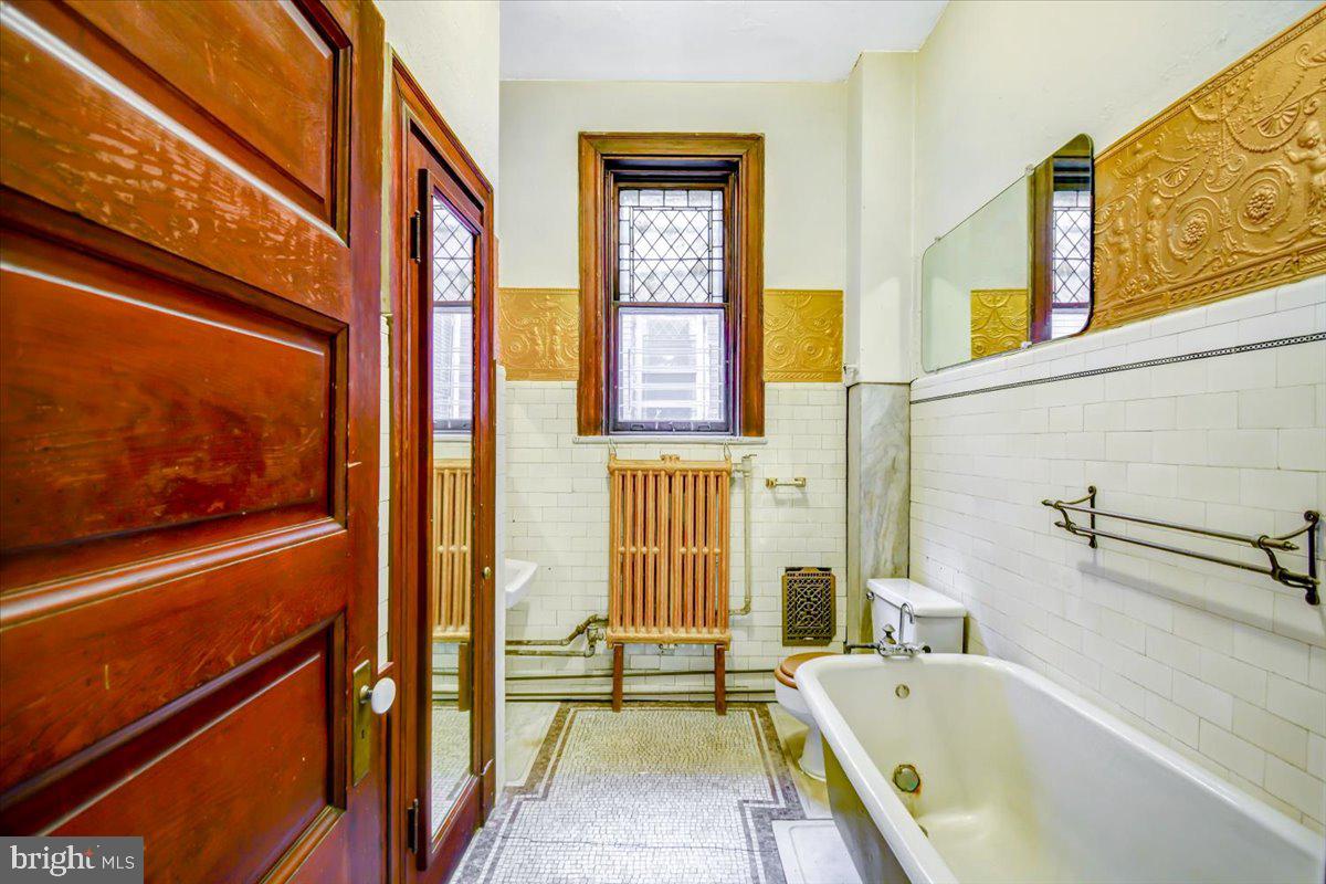 1718 Eutaw Place Baltimore, MD 21217 - Photo 41 of 65 tile walls Cast iron claw tub & marble mosaic flrs