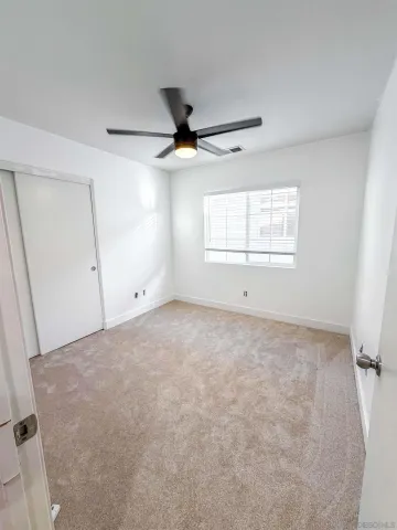 an empty room with a empty space and windows