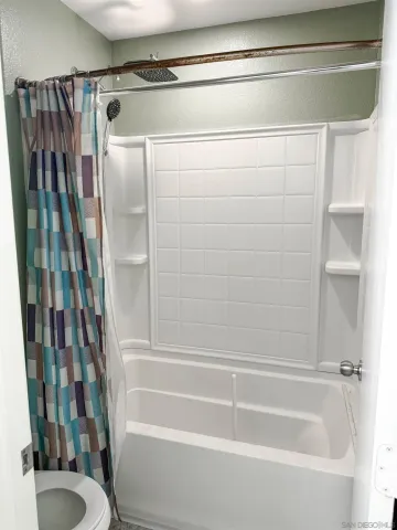 a bathroom with a shower and a toilet