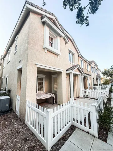 a view of a house with a small yard